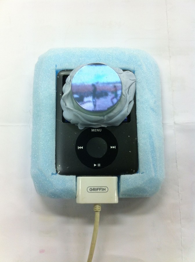 An iPod mini embedded in the eye, with a lens showing video