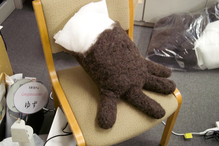 Needle-felted wool leg parts resting on a chair